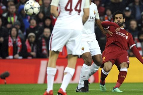 Liverpool's Mohamed Salah, right, kicks the ball during the Champions League semifinal, first leg, soccer match between Liverpool and Roma at Anfield Stadium, Liverpool, England, Tuesday, April 24, 2018. (AP Photo/Rui Vieira)