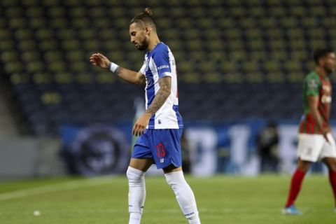 Porto's Alex Telles leaves the pitch after being shown a second yellow card during the Portuguese League soccer match between FC Porto and Maritimo in Porto, Portugal, Wednesday, June 10, 2020. The Portuguese League soccer matches are being played without spectators because of the coronavirus pandemic. (Jose Coelho/Pool via AP)