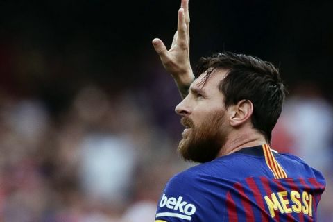 Barcelona's Lionel Messi celebrates scoring the opening goal during a Spanish La Liga soccer match between Barcelona and Huesca at the Camp Nou stadium in Barcelona, Spain, Sunday Sept. 2, 2018. (AP Photo/Eric Alonso)