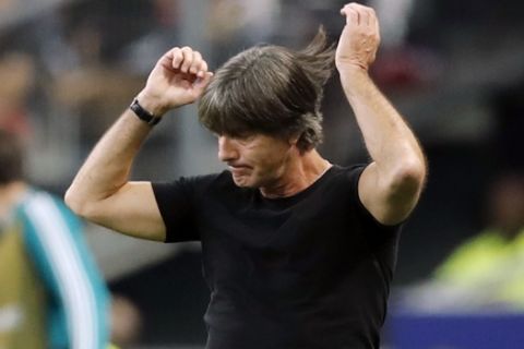 FILE - In this file photo dated Tuesday, Oct. 16, 2018, Germany's head coach Joachim Loew reacts as he watches his players during a UEFA Nations League soccer match between France and Germany at Stade de France stadium in Saint Denis, north of Paris. Germany is last in the group, having collected one point from three games, and is on the brink of relegation but coach Joachim Loews decision to stay on in the role is under as much scrutiny as the teams mettle. (AP Photo/Christophe Ena, FILE)