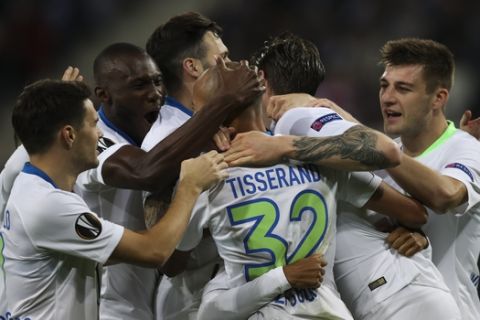 Wolfsburg players celebrates after teammate Wout Weghorst scored the opening goal during the Europa League group I soccer match between Gent and Wolfsburg at KAA Gent Stadium in Ghent, Belgium, Thursday, Oct. 24, 2019. The match ended in a 2-2 draw. (AP Photo/Francisco Seco)