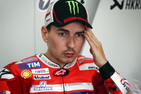 MotoGP rider Jorge Lorenzo of Spain, rests on the second day of winter testing in Sepang, Malaysia, Tuesday, Jan. 31, 2017. (AP Photo/Vincent Thian)