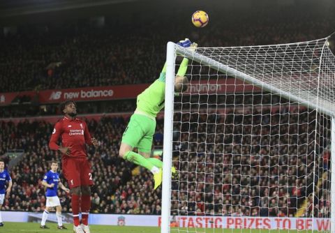 Everton goalkeeper Jordan Pickford, right, saves a ball in front of Liverpool forward Divock Origi before he scores his side's first goal during the English Premier League soccer match between Liverpool and Everton at Anfield Stadium in Liverpool, England, Sunday, Dec. 2, 2018. (AP Photo/Jon Super)