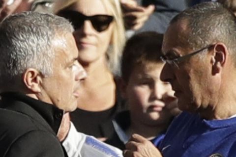 ManU coach Jose Mourinho and Chelsea's manager Maurizio Sarri, right, talk after the 2-2 draw in their English Premier League soccer match between Chelsea and Manchester United at Stamford Bridge stadium in London Saturday, Oct. 20, 2018. (AP Photo/Matt Dunham)