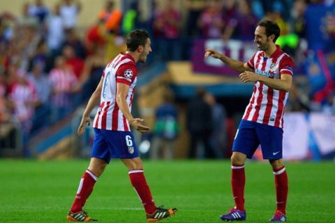 MADRID, SPAIN - APRIL 09:  Koke of Club Atletico de Madrid and Juanfran of Club Atletico de Madrid celebrate victory during the UEFA Champions League Quarter Final second leg match between Club Atletico de Madrid and FC Barcelona at Vicente Calderon Stadium on April 9, 2014 in Madrid, Spain.  (Photo by Gonzalo Arroyo Moreno/Getty Images)