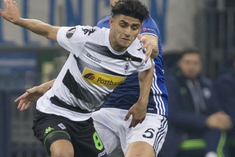 Gladbach's Mahmoud Dahoud, front, and Schalke's Johannes Geis in action during the Europa League round of 16 first leg soccer match between FC'Schalke 04 and Borussia Moenchengladbach at the Veltins Arena in Gelsenkirchen, Germany, Thursday, March 9, 2017. (Guido Kirchner/DPA via AP)