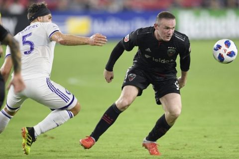 D.C. United forward Wayne Rooney, right, chases the ball against Orlando City midfielder Dillon Powers (5) during the second half of an MLS soccer match, Sunday, Aug. 12, 2018, in Washington. D.C. United won 3-2. (AP Photo/Nick Wass)