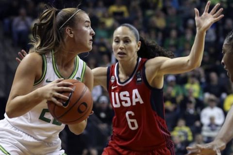 Oregon's Sabrina Ionescu, left, move the ball under pressure from U.S.'s Sue Bird, center, and Nnemkadi Ogwumike during the first half of an women's exhibition basketball game in Eugene, Ore., Saturday, Nov. 9, 2019. (AP Photo/Chris Pietsch)