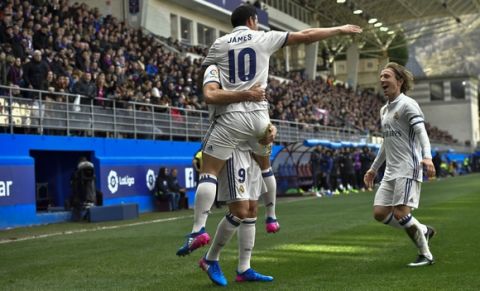 Real Madrid's James Rodriguez, celebrates after scoring his team's third goal with teammate Luka Modric, right, during the Spanish La Liga soccer match between Real Madrid and Eibar, at Ipurua stadium, in Eibar, northern Spain, Saturday, March 4, 2017. (AP Photo/Alvaro Barrientos)