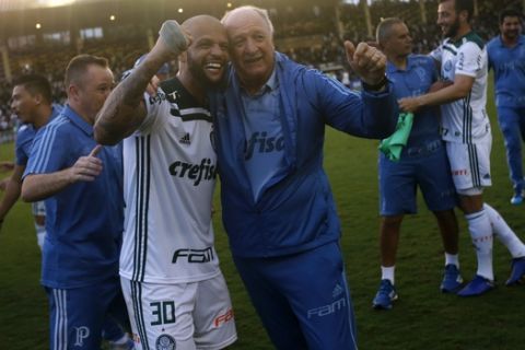 Palmeiras' coach Luiz Felipe Scolari, right, and his player Felipe Melo celebrate after winning the Brazilian Championship against Vasco in Rio de Janeiro, Brazil, Sunday, Nov. 25, 2018. (AP Photo/Silvia Izquierdo)