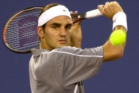 Roger Federer, of Switzerland, returns a serve to Andy Roddick in the first set of their semi-final match at the Tennis Masters Cup Saturday, Nov. 15, 2003, in Houston. (AP Photo/Pat Sullivan)
