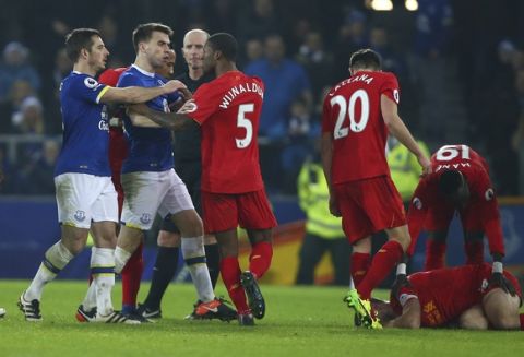 Liverpool's Georginio Wijnaldum, third left, and Everton's Leighton Baines, left, have words during the English Premier League soccer match between Everton and Liverpool at Goodison Park stadium in Liverpool, England, Monday, Dec. 19, 2016. (AP Photo/Dave Thompson)