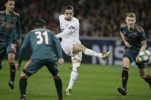 Lille's Yusuf Yazici, 2nd right, kicks the ball while Ajax's Noussair Mazraoui, left, Ajax's Nicolas Tagliafico, 2nd left, and Ajax's Perr Schuurs looks on during the group H Champions League soccer match between LOSC Lille and Ajax at the Stade Pierre Mauroy - Villeneuve d'Ascq stadium in Lille, France, Wednesday, Nov. 27, 2019. (AP Photo/Michel Spingler)