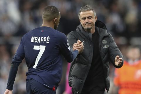 PSG's Kylian Mbappe, shakes hands with PSG's head coach Luis Enrique at the end of the Champions League group F soccer match between Newcastle and Paris Saint Germain at St. James' Park, Wednesday, Oct. 4, 2023, in Newcastle, England. (AP Photo/Scott Heppell)