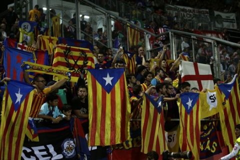 Supporters hold "estelada" or pro independence flag and banners calling for voting Yes on a planned independence referendum during the Spanish La Liga soccer match between Girona and FC Barcelona at the Montilivi stadium in Girona, Spain, Saturday, Sept. 23, 2017. (AP Photo/Manu Fernandez)