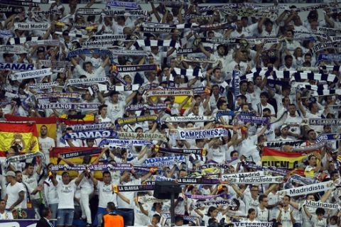 Real Madrid fans watch the Champions League group H soccer match between Real Madrid and Apoel Nicosia at the Santiago Bernabeu stadium in Madrid, Spain, Wednesday, Sept. 13, 2017. (AP Photo/Paul White)