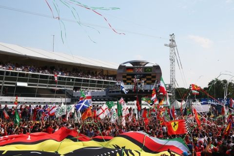 MONZA, ITALY - SEPTEMBER 07:  The fans cheer the drivers on the podium during the F1 Grand Prix of Italy at Autodromo di Monza on September 7, 2014 in Monza, Italy.  (Photo by Bryn Lennon/Getty Images)