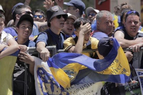 Boca Juniors soccer fans gather outside the hotel where their team is staying in Buenos Aires, Argentina, Sunday, Nov. 25, 2018. In one of the most embarrassing weekends in South American football history, the Copa Libertadores final between arch rivals Boca Juniors and River Plate was once more postponed on Sunday. The same decision was made on Saturday after Boca's bus was attacked by River fans. (AP Photo/Ana Mombello)