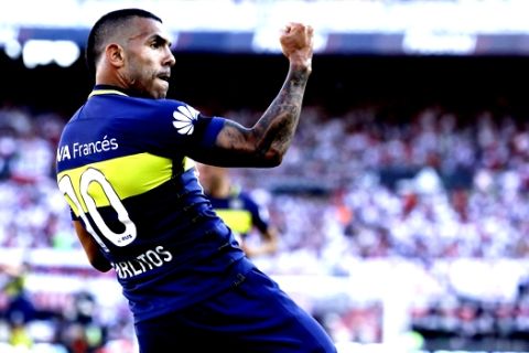 FILE - In this Dec. 11, 2016 file photo, Boca Juniors' forward Carlos Tevez celebrates scoring against River Plate during a local tournament soccer match in Buenos Aires, Argentina. Tevez agreed on Friday, Jan. 5, 2018, to return to Boca Juniors after a tumultuous period with Shanghai Shenhua in the Chinese Super League. (AP Photo/Natacha Pisarenko, File)