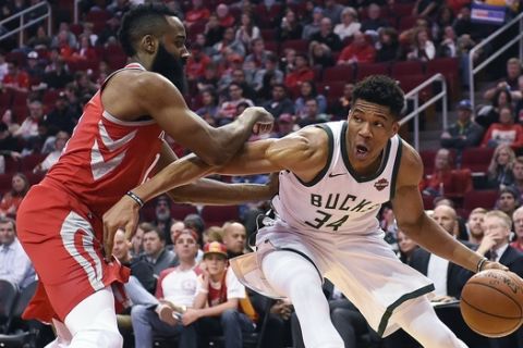 Milwaukee Bucks forward Giannis Antetokounmpo (34) drives as Houston Rockets guard James Harden defends during the first half of an NBA basketball game, Saturday, Dec. 16, 2017, in Houston. (AP Photo/Eric Christian Smith)