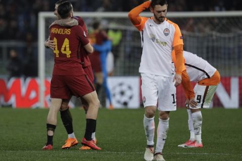 Roma's Kostas Manolas and Aleksandar Kolarov celebrate their side's 1-0 win at the end of a Champions League round of 16 second-leg soccer match between Roma and Shakhtar Donetsk, at the Rome Olympic stadium, Tuesday, March 13, 2018. (AP Photo/Gregorio Borgia)