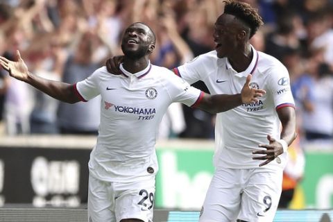 Chelsea's Fikayo Tomori, left, celebrates scoring his side's first goal of the game with teammate Tammy Abraham during their English Premier League soccer match against Wolverhampton Wanderers at Molineux, Wolverhampton, England, Saturday, Sept. 14, 2019. (Nick Potts/PA via AP)