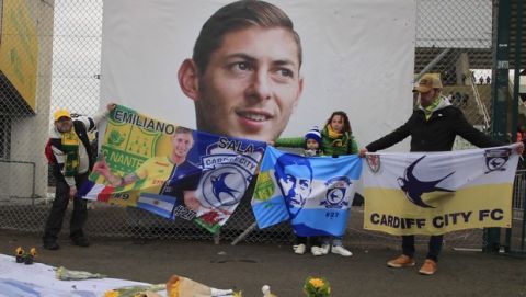 Cardiff supporters gather to pay tribute to Argentinian soccer player Emiliano Sala prior the French League One soccer match between Nantes against Bordeaux at La Beaujoire stadium in Nantes, western France, Sunday, Jan. 26, 2020. Nantes paid an emotional tribute to Emiliano Sala by wearing a special blue and white shirt representing the Argentina team's colors during its home game against Bordeaux. Sala died after the single-engine aircraft carrying him from Nantes to his new club Cardiff crashed near the Channel Island of Guernsey on Jan. 21 last year. (AP Photo/Michel Euler)