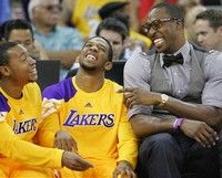Los Angeles Lakers' Andrew Goudelock, left, and Darius Morris laugh with new teammate Dwight Howard in the first half of an NBA basketball game against the Golden State Warriors in Fresno, Calif., Sunday, Oct. 7, 2012. (AP Photo/Gary Kazanjian)