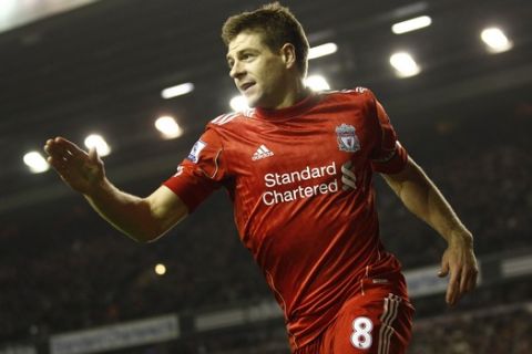 Liverpool's Steven Gerrard celebrates after scoring his second goal against Everton during their English Premier League soccer match at Anfield Stadium, Liverpool, England, Tuesday, March 13, 2012. (AP Photo/Jon Super)