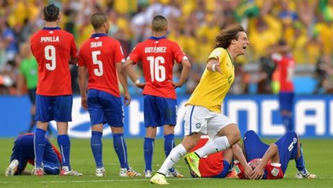BELO HORIZONTE, BRAZIL - JUNE 28: David Luiz of Brazil celebrates after defeating Chile in a penalty shootout during the 2014 FIFA World Cup Brazil round of 16 match between Brazil and Chile at Estadio Mineirao on June 28, 2014 in Belo Horizonte, Brazil.  (Photo by Buda Mendes/Getty Images)