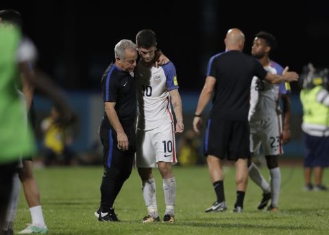 United States' Christian Pulisic, (10) is comforted after losing 2-1 against Trinidad and Tobago during a 2018 World Cup qualifying soccer match  in Couva, Trinidad, Tuesday, Oct. 10, 2017. (AP Photo/Rebecca Blackwell)