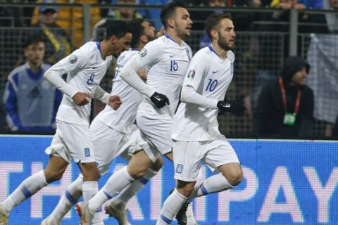 Greek players celebrate their team's second goal during the Euro 2020 group J qualifying soccer match between Bosnia-Herzegovina and Greece in Zenica, Bosnia, Tuesday, March 26, 2019. (AP Photo/Darko Bandic)