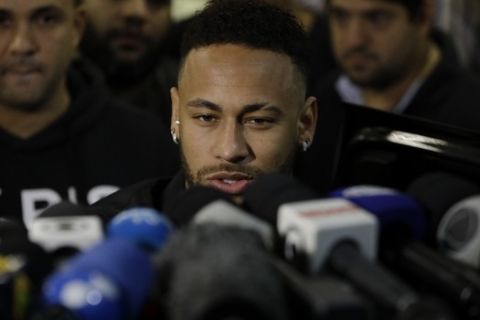 Brazilian soccer player Neymar speaks to journalists as he leaves a police station where he spoke to police in Rio de Janeiro, Brazil, Thursday, June 6, 2019. Rio de Janeiro police said Thursday that soccer star Neymar was expected to testify in the investigation linked to a woman's rape allegation against him. (AP Photo/Leo Correa)