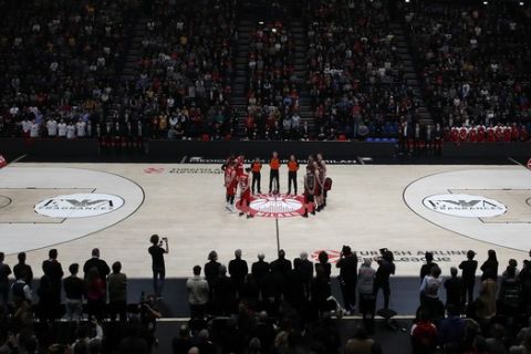 Olimpia Milan and Bayern Munich players observe a minute's silence in memory of Kobe Bryant, prior to the start of the Euro League basketball match between Olimpia Milan and Bayern Munich, in Milan, Italy, Thursday, Jan. 30, 2020. Bryant, an 18-time NBA All-Star with the Los Angeles Lakers and a lifelong soccer fan, died Sunday with his 13-year-old daughter, Gianna, in a helicopter crash near Calabasas, California. He was 41. (AP Photo/Antonio Calanni)