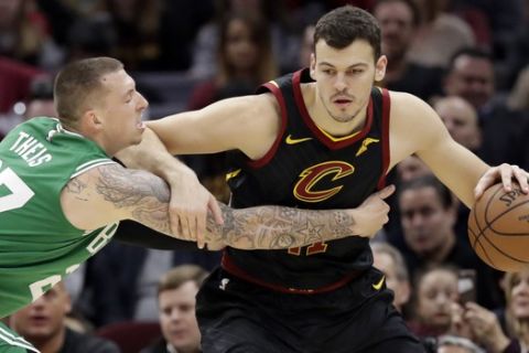 Cleveland Cavaliers' Ante Zizic, right, from Croatia, drives past Boston Celtics' Daniel Theis (27) during the first half of an NBA basketball game Tuesday, Feb. 5, 2019, in Cleveland. (AP Photo/Tony Dejak)