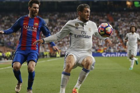 Real Madrid's Mateo Kovacic, right, controls the ball in front of Barcelona's Lionel Messi during a Spanish La Liga soccer match between Real Madrid and Barcelona, dubbed 'el clasico', at the Santiago Bernabeu stadium in Madrid, Spain, Sunday, April 23, 2017. (AP Photo/Daniel Ochoa de Olza)