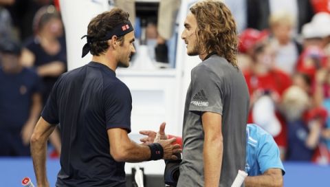 Switzerland's Roger Federer, left, shakes hands with Stefanos Tsitsipas of Greece at the net after winning their match at the Hopman Cup in Perth, Australia, Thursday Jan. 3, 2019. (AP Photo/Trevor Collens)