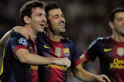 Barcelona's Argentinian forward Lionel Messi (L) is congratuled by his teammate Barcelona's forward David Villa (R) after scoring during the UEFA Champions League football match FC Barcelona against FC Spartak Moscou  at the Camp Nou stadium in Barcelona on September 19, 2012. AFP PHOTO/ JOSEP LAGO        (Photo credit should read JOSEP LAGO/AFP/GettyImages)