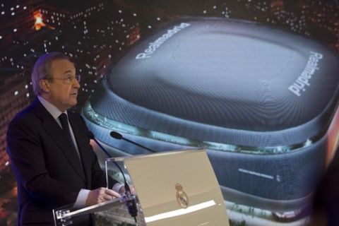 Real Madrid's President Florentino Perez makes a speech in front of an artist's image of the proposed new Santiago Bernabeu stadium during a presentation to remodel the stadium in Madrid, Spain, Tuesday, April 2, 2019. (AP Photo/Paul White)