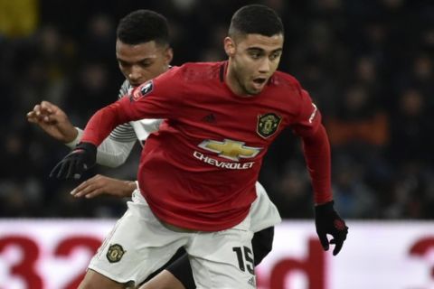 Manchester United's Andreas Pereira, front, duels for the ball with Derby's Morgan Whittaker during the FA Cup fifth round soccer match between Derby County and Manchester United at Pride Park in Derby, England, Thursday, March 5, 2020. (AP Photo/Rui Vieira)