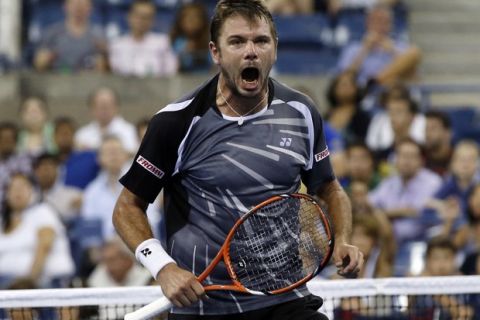 Stan Wawrinka of Switzerland celebrates after defeating Thomaz Bellucci of Brazil in a 4th set tie-break during their match at the 2014 U.S. Open tennis tournament in New York August 27, 2014.   REUTERS/Shannon Stapleton (UNITED STATES  - Tags: SPORT TENNIS) ORG XMIT: NYO522