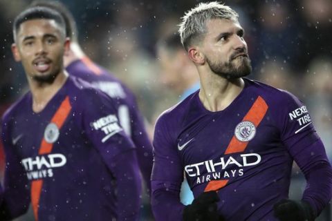 Manchester City's Sergio Aguero, right, celebrates scoring his side's third goal of the game during their English FA Cup quarter final soccer match against Swansea City at the Liberty Stadium, Swansea, Wales, Saturday, March 16, 2019. (Nick Potts/PA via AP)