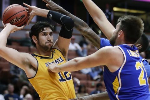 UC Irvine's Ioannis Dimakopoulos, left, looks to pass under pressure from UC Riverside's Alex Larsson, right, and Secean Johnson during the second half of an NCAA college basketball game at the Big West conference men's tournament Thursday, March 9, 2017, in Anaheim, Calif. UC Irvine won 76-67. (AP Photo/Jae C. Hong)