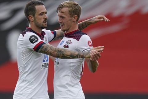 Southampton's Danny Ings, left, celebrates with teammate James Ward-Prowse after scoring his side's opening goal during the English Premier League soccer match between Bournemouth and Southampton at Vitality Stadium in Bournemouth, England, Sunday, July 19, 2020. (Will Oliver/Pool Photo via AP)