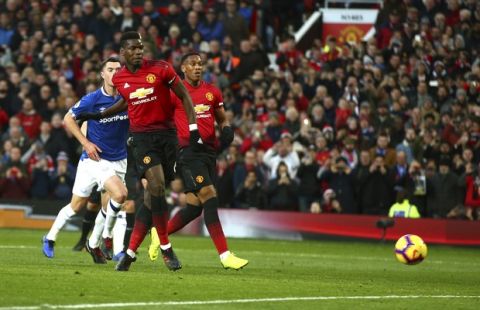 Manchester United's Paul Pogba scores the opening goal during the English Premier League soccer match between Manchester United and Everton FC at Old Trafford in Manchester, England, Sunday Oct. 28, 2018. (AP Photo/Dave Thompson)