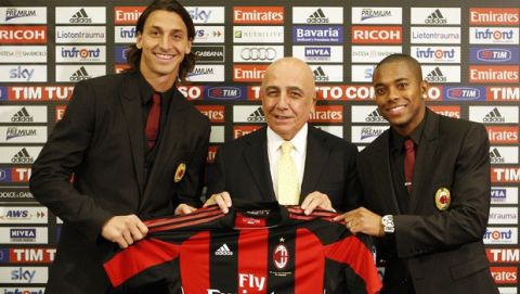 AC Milan newly signed soccer forward Zlatan Ibrahimovic, of Sweden, left, vice president Adriano Galliani, center, and Brazilian striker Robinho pose with a team jersey during the official presentation in downtown Milan, Italy, Thursday, Sept 9, 2010. (AP Photo/Antonio Calanni)