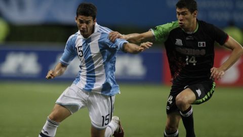 Argentina's Lucas Villafane, left, fights for the ball with Mexico's Jorge Enriquez during a men's soccer gold medal match at the Pan American Games in Guadalajara, Mexico, Friday, Oct. 28, 2011. Mexico won 1-0. (AP Photo/Eduardo Verdugo)