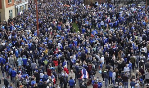 Leicester City fans gather at Jubilee Square in Leicester, before taking part in a memorial walk to the King Power Stadium, in honour of the club's owner Vichai Srivaddhanaprabha and four others who died in a helicopter crash outside the stadium on October 27.  Saturday Nov. 10, 2018. (Aaron Chown/PA via AP)