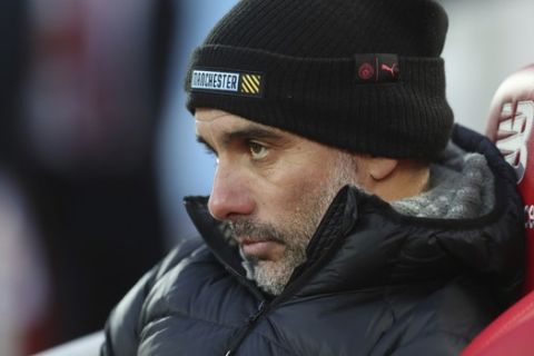 Manchester City's head coach Pep Guardiola, watches from the bench prior to the start of the English Premier League soccer match between Liverpool and Manchester City at Anfield stadium in Liverpool, England, Sunday, Nov. 10, 2019. (AP Photo/Jon Super)