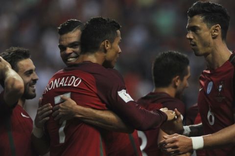Portugal's Cristiano Ronaldo, center, is congratulated by his teammates after scoring his side's second goal during the World Cup Group B qualifying soccer match between Portugal and Faroe Islands at the Bessa Stadium in Porto, Portugal, Thursday Aug. 31, 2017. (AP Photo/Paulo Duarte)